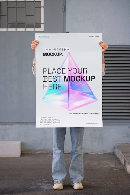 PSD person holding poster mockup