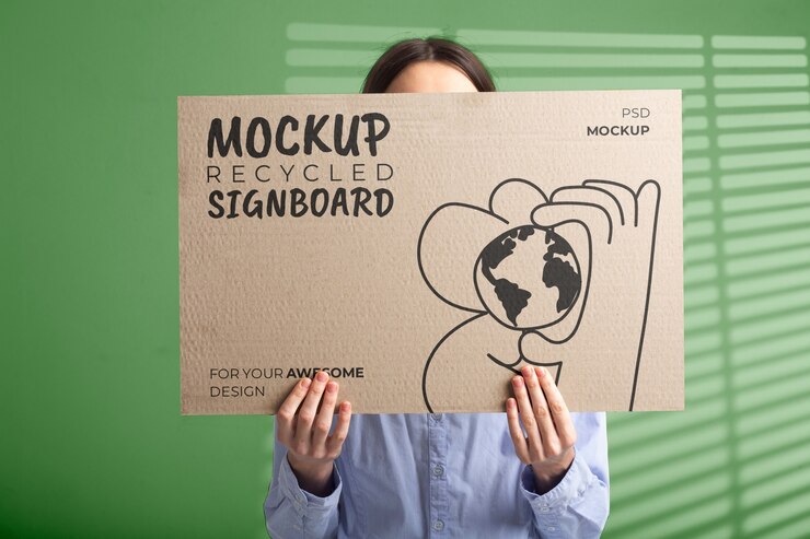 PSD person holding signboard with drawing from recycled paper