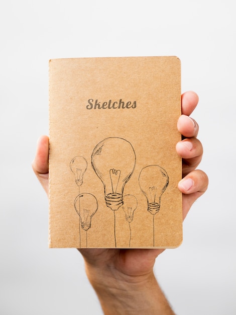 Person holding a sketch book