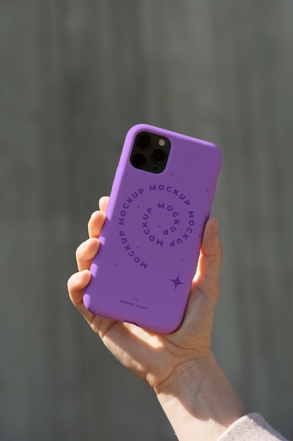 Person holding smartphone mock-up outdoors