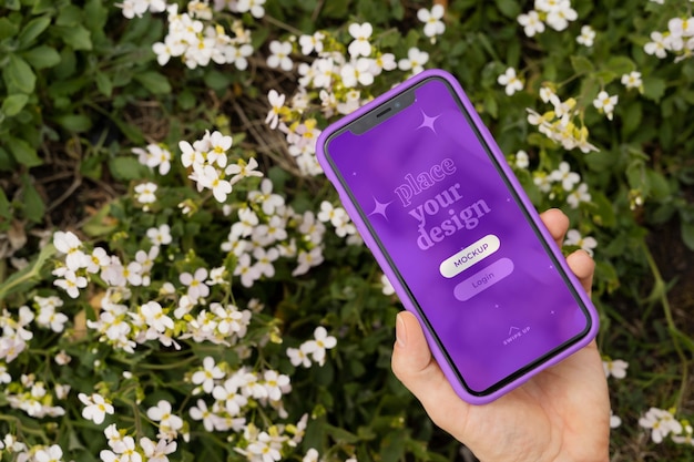 Person holding smartphone mock-up outdoors