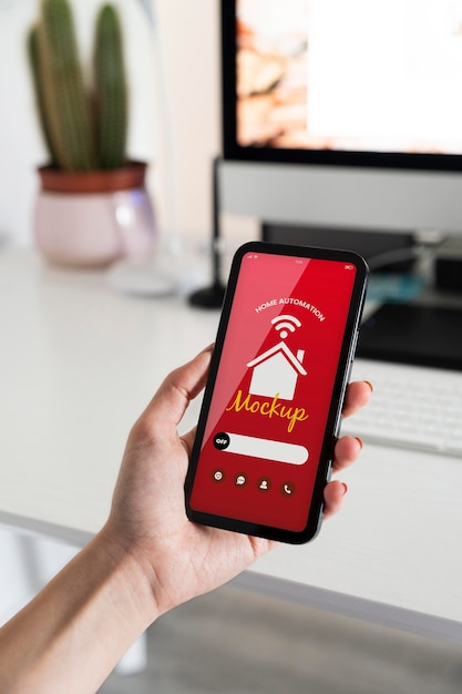 person holding a smartphone with a home automation app