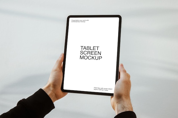 PSD una persona in possesso di un tablet con mockup dello schermo