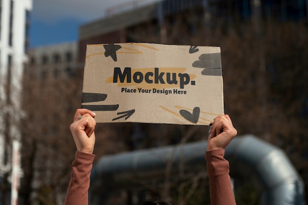Person holding up a sign mockup