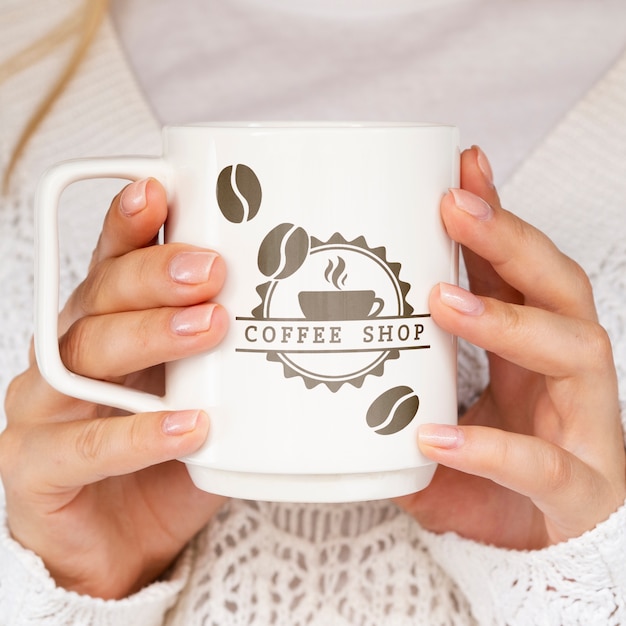 PSD person holding white mug mock-up