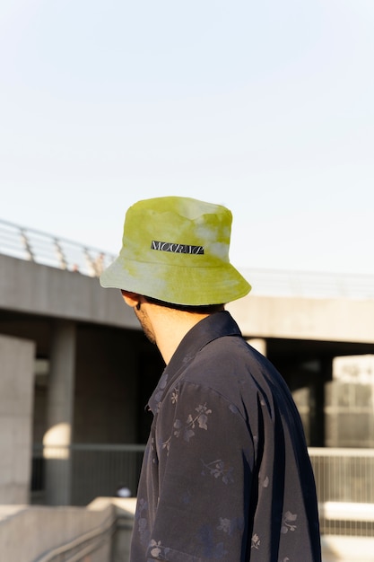 Person modeling bucket hat outdoors