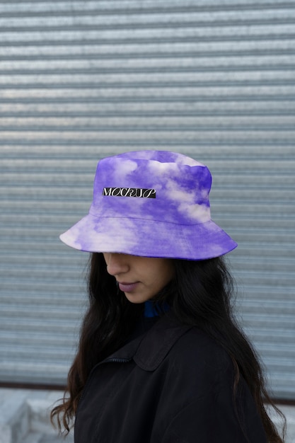 Person modeling bucket hat outdoors