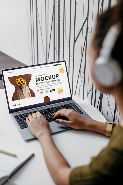 Person  in modern place using laptop mockup