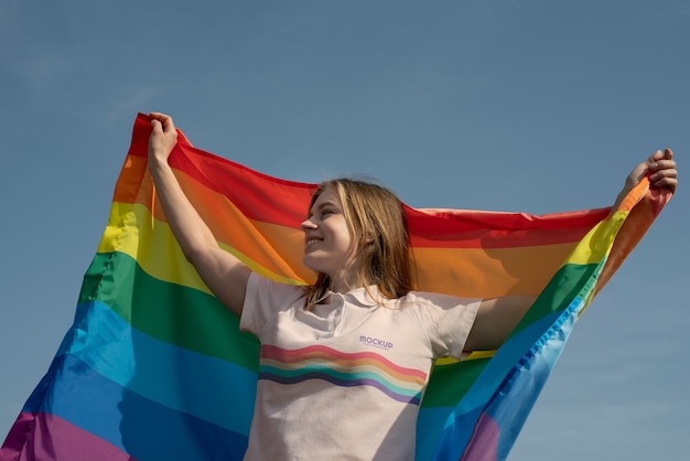 Person outdoors with rainbow pride flag