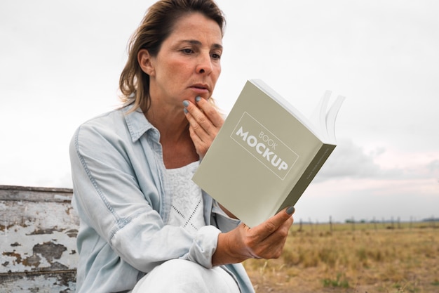 Person reading book mockup