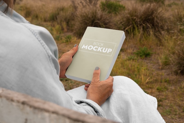 PSD person reading book mockup