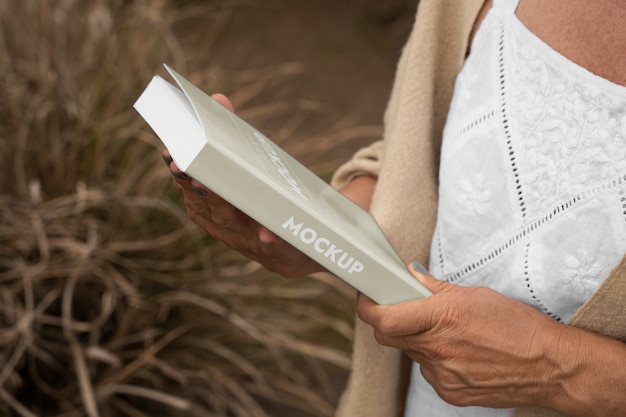 Person reading book mockup