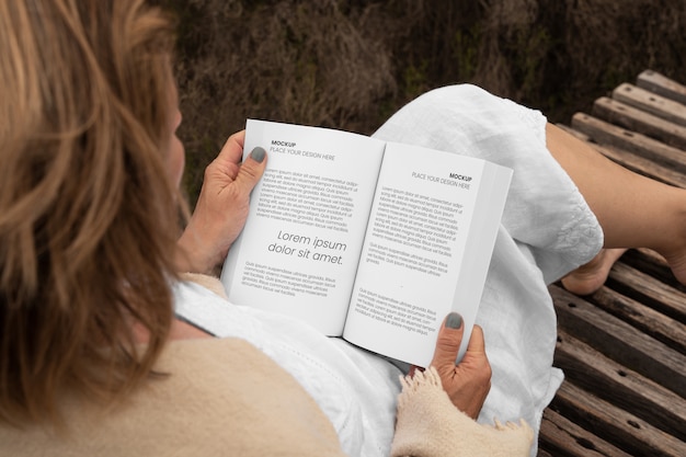 Person reading book mockup