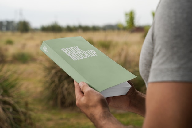 PSD person reading book mockup