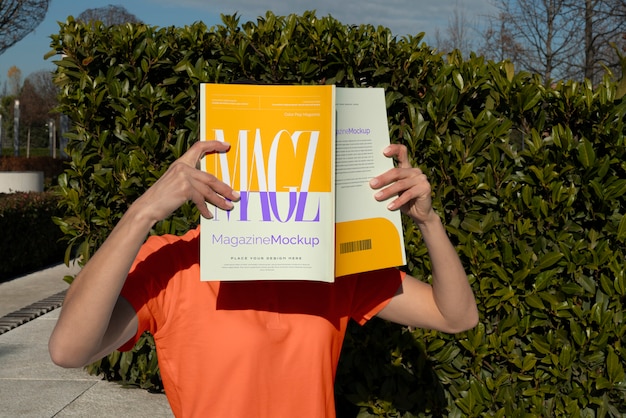 person reading color pop magazine with cover mockup