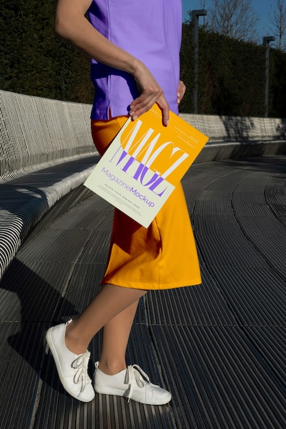 Person reading color pop magazine with cover mockup