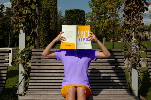 Person reading color pop magazine with cover mockup