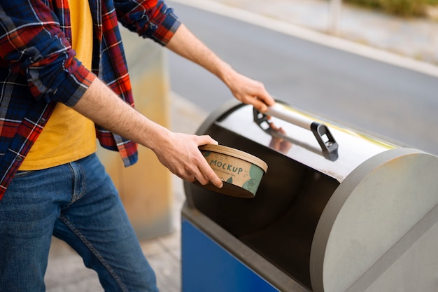 PSD person throwing away trash in recycling bin