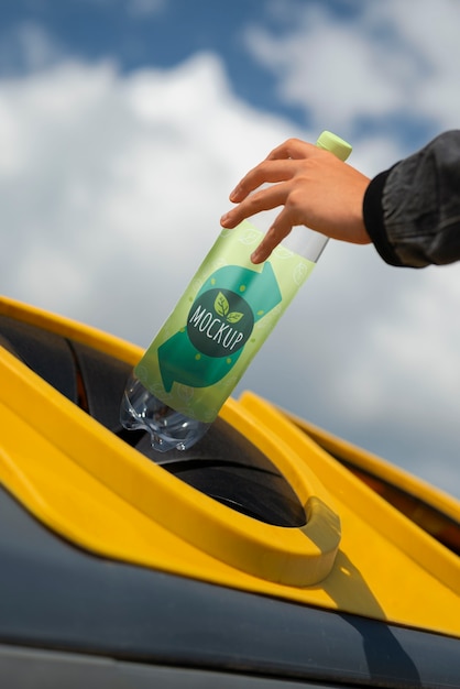 PSD person throwing away trash in recycling bin