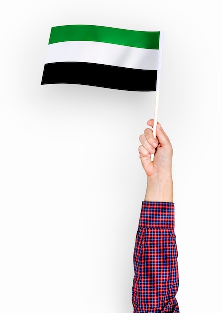 Person waving the flag of islamic state of afghanistan