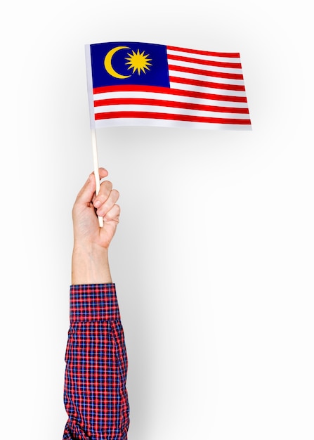 Person waving the flag of malaysia