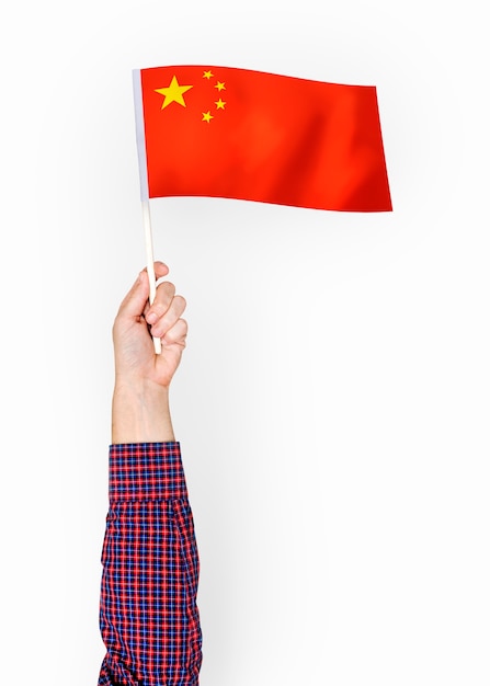 Person waving the flag of the Peoples Republic of China