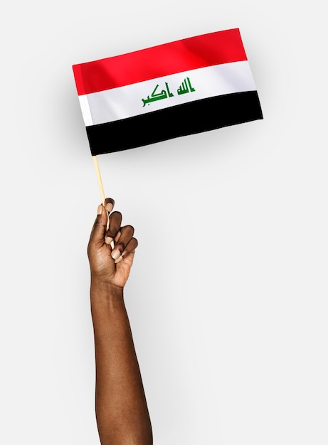 Person waving the flag of republic of iraq