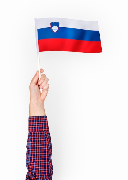 Person waving the flag of Republic of Slovenia