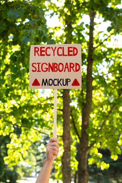 PSD person with a recycled signboard mockup