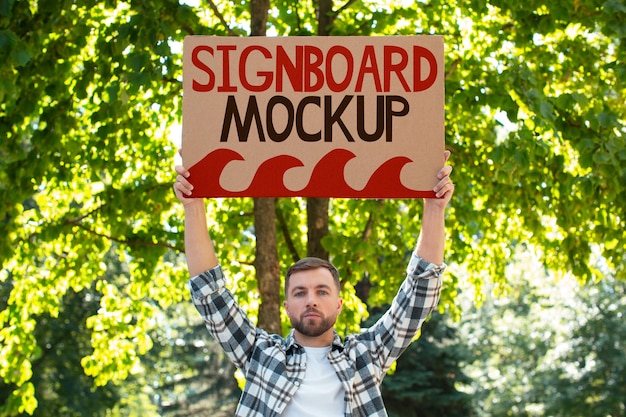 PSD person with a recycled signboard mockup