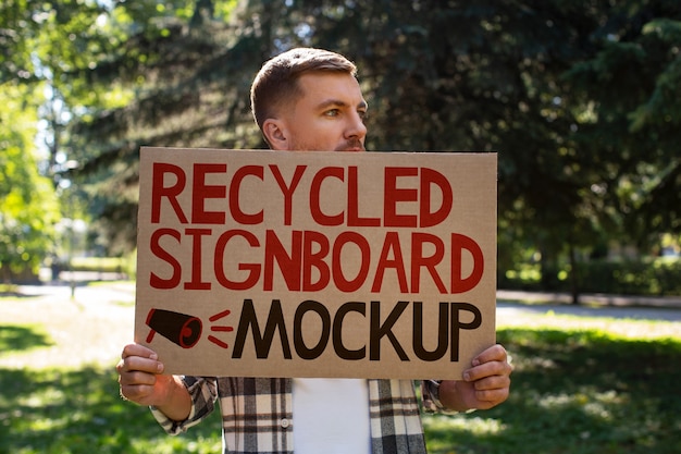 person with a recycled signboard mockup