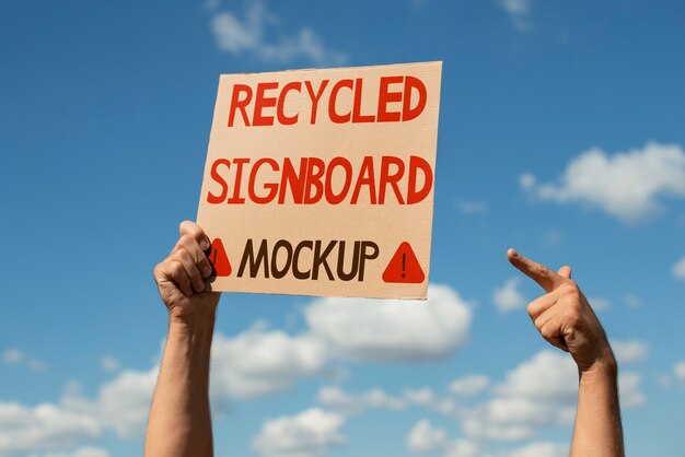 PSD person with a recycled signboard mockup