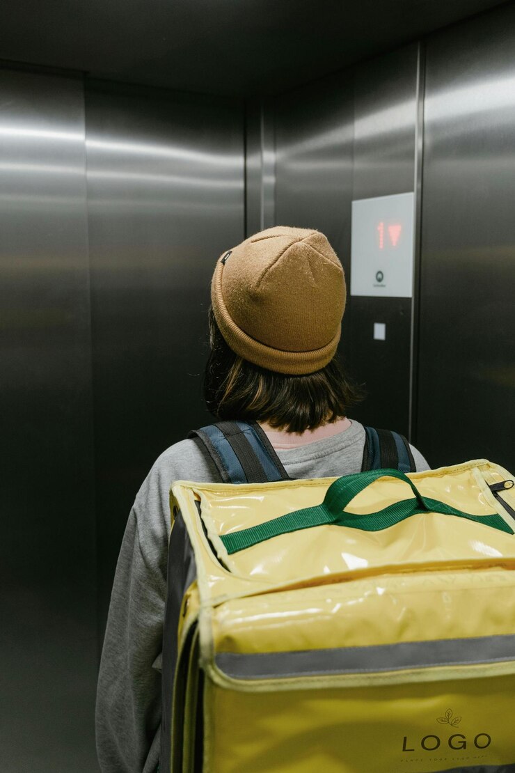 PSD a person with a yellow bag in front of a elevator with the number 3 on it