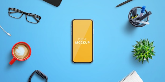 phone mockup on blue office desk surrounded by office supplies. isolated screen for mockup, web site or app presentation. top vie, flat lay