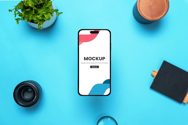 Phone mockup above a desk with objects around