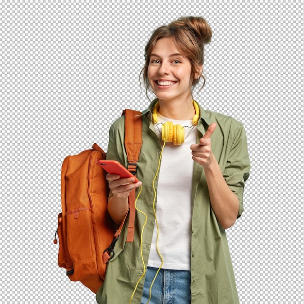 Photo of delighted European woman points at you happily holds smartphone device connected to headphones uses music app