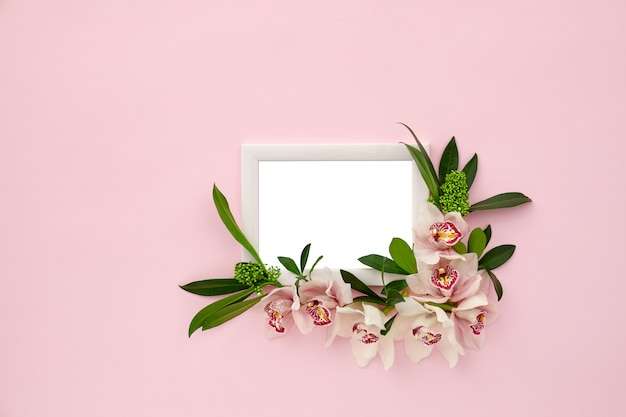 Photo frame decorated with green leaves and orchid flowers