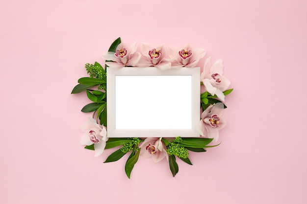 Photo frame decorated with green leaves and orchid flowers