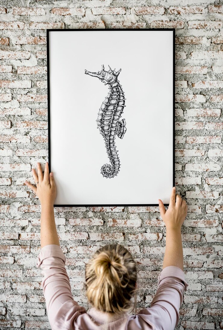 PSD photo of hand drawing seahorse is hanging on the wall