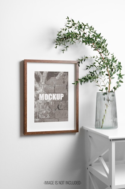 PSD photo or picture frame mockup in minimalistic interior with green eucalyptus