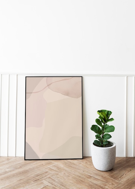 Picture frame mockup by a fiddle-leaf fig plant on a parquet floor