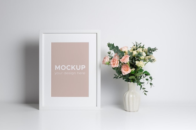 Picture frame mockup in minimalistic interior with flowers bouquet