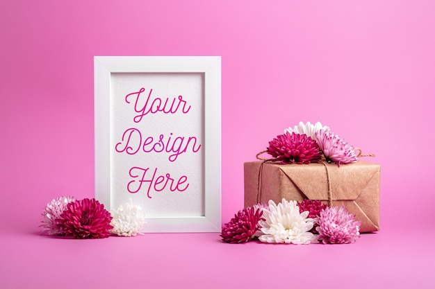 Picture frame mockup with eco zero waste wrapping style gift box and flowers