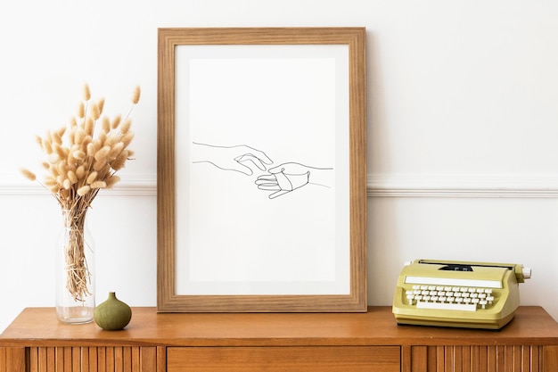 Picture frame mockup on a wooden sideboard table by a typewriter