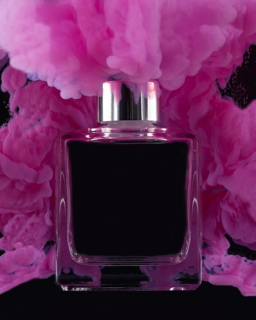 Pink smoke and perfume bottle