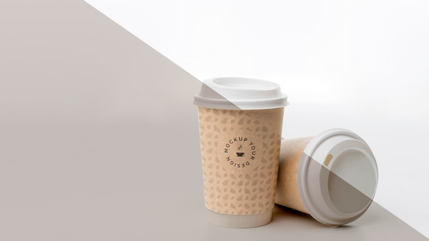 PSD plastic cup with coffee mock up on table