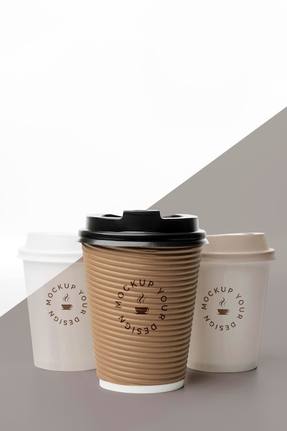 PSD plastic cups with coffee mock up on table