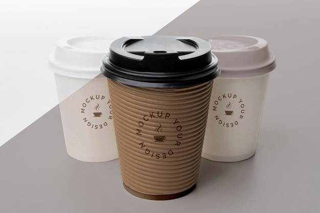 PSD plastic cups with coffee mock up on table