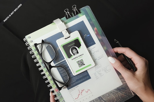 Plastic Id card on spiral notepad in woman's hands mockup