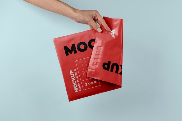 Plastic post pack mockup held in hands